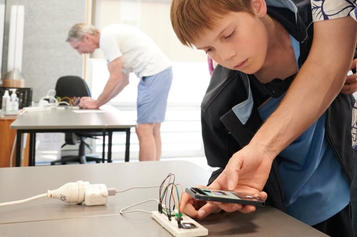Picture of a student holding a camera rig.